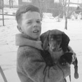 Holding dog as little boy